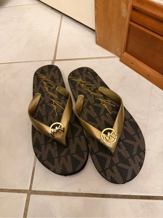 Michael Kors Shoes - Michael Kors Brown Monogram Flip Flops with Gold Straps Women’s size 7